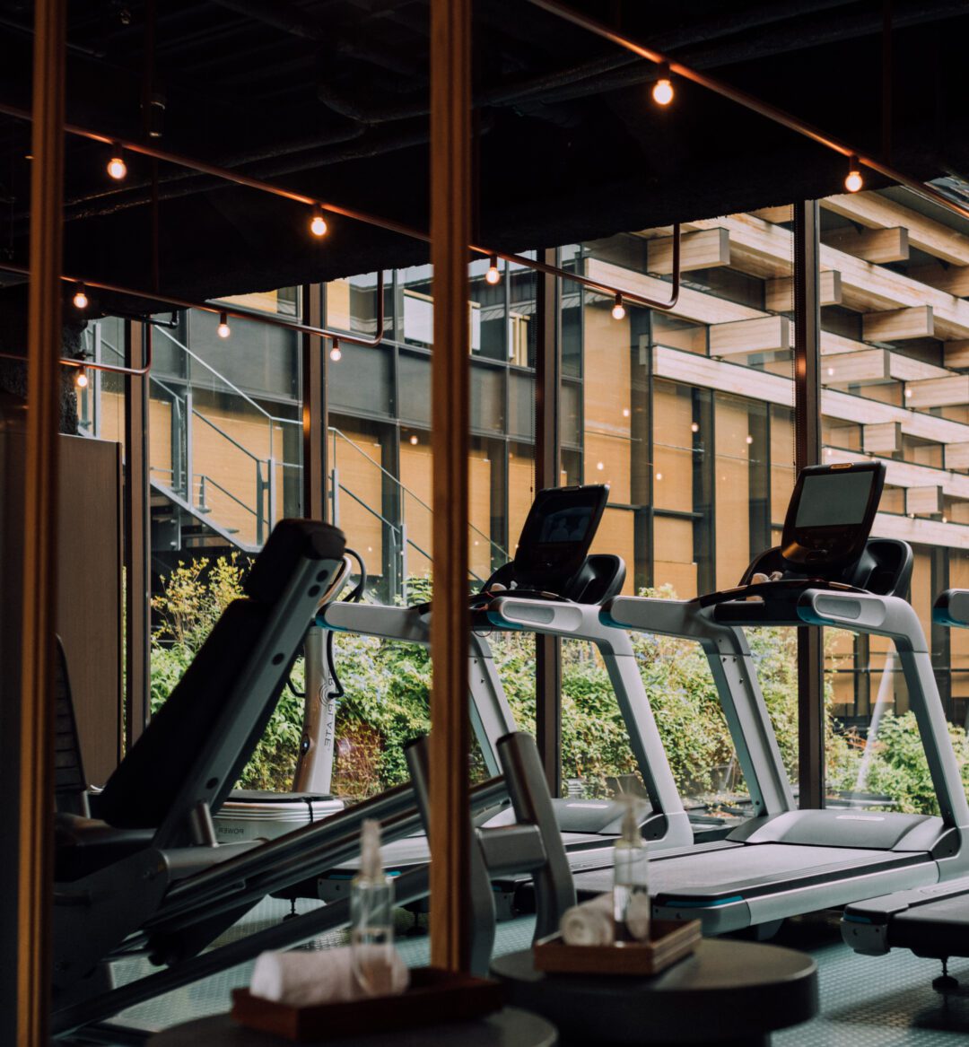 a photo of a gym with equipment that includes treadmills and cross trainer / elliptical trainer machine.