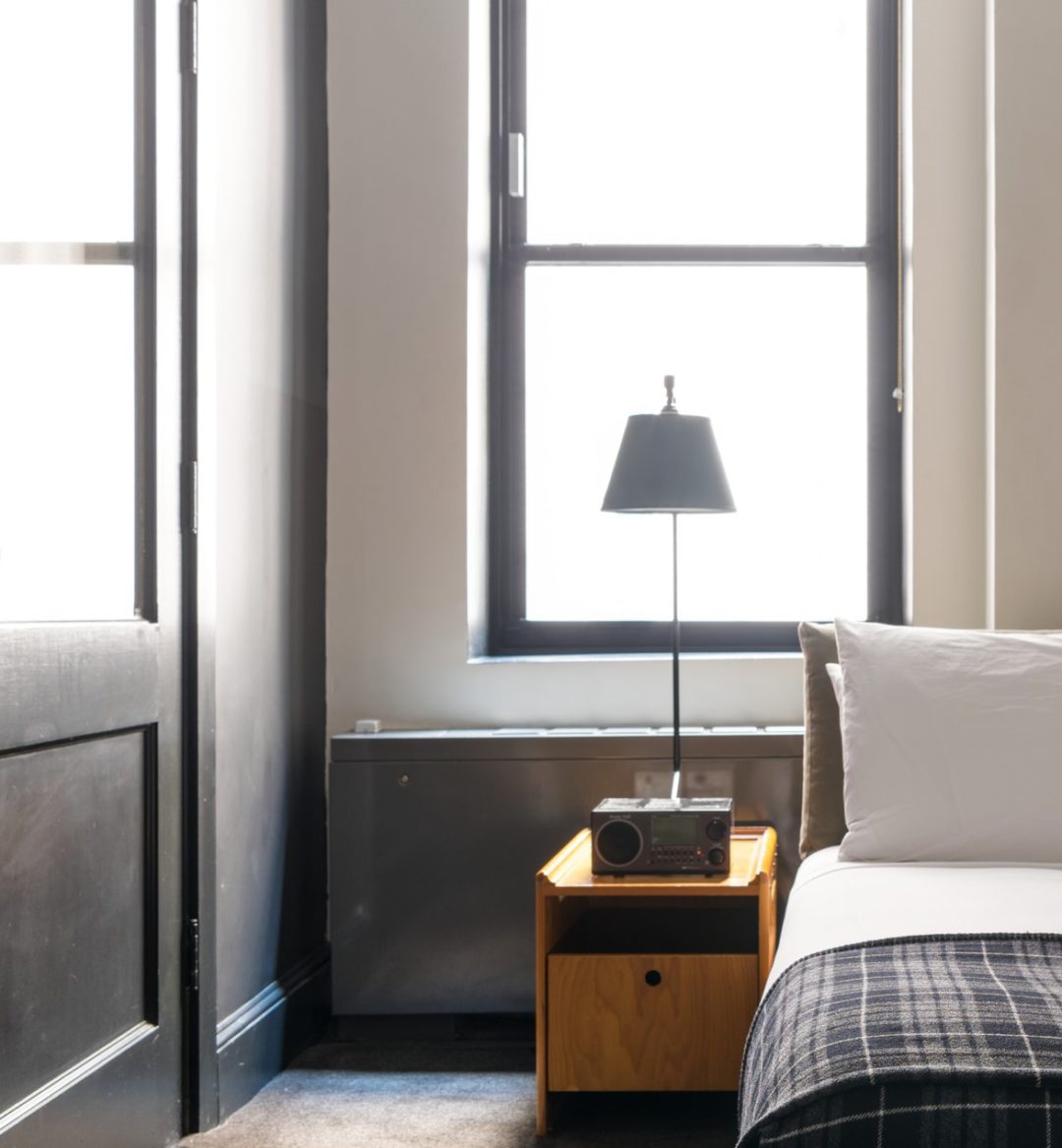 A room with a modern style features a window providing natural light